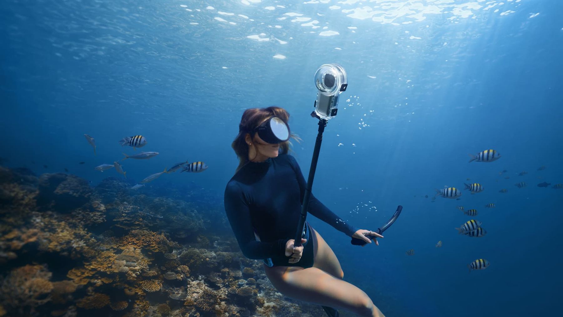 Freediver filming a reef with the X4 Air